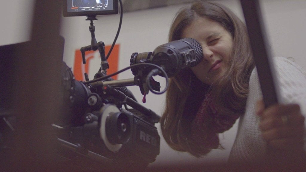 Estudiantes de UCF Escuela de Cine en Montevideo trabajando en equipo en un set de filmación, reflejando la pasión y dedicación en la carrera de Realización Audiovisual.